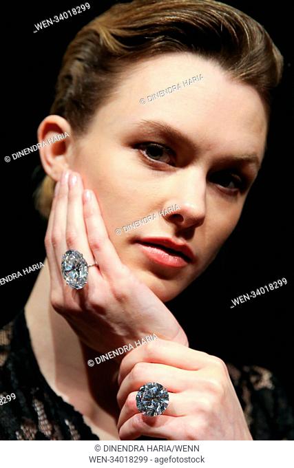 A model holds 51.71 carat white round brilliant cut and 50.39 carat white oval diamonds at Sotheby’s London. The diamonds will be at an auction in Geneva on 15...