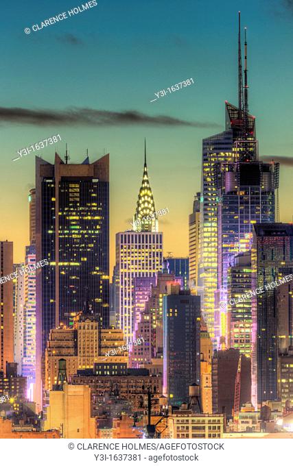 The Chrysler Building, Bank of America Tower, and other buildings near 42nd Street in New York City during morning twilight as viewed over the Hudson River...