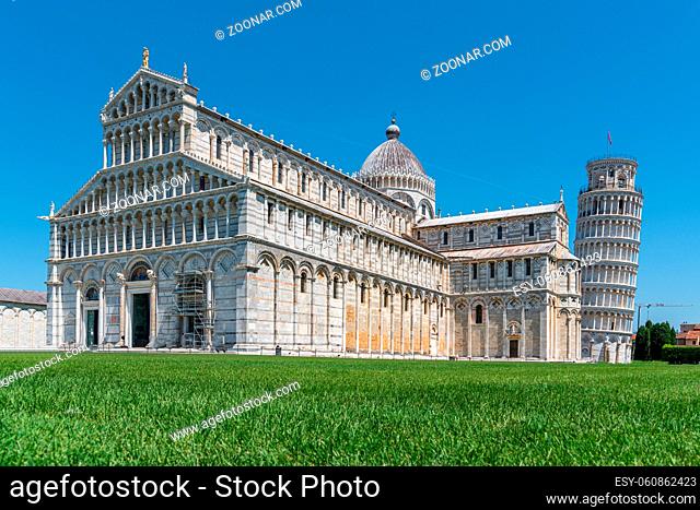 the Leaning Tower of Pisa and the Cathedral of Pisa in front of a bright blue sky