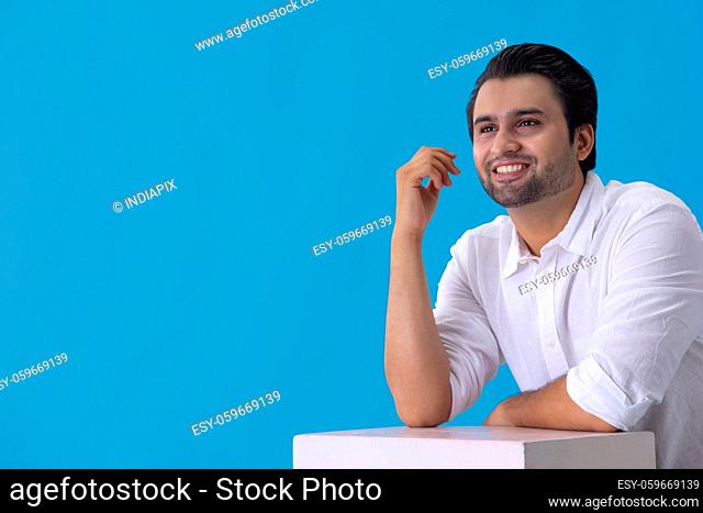 Portrait of a young man smiling while thinking something