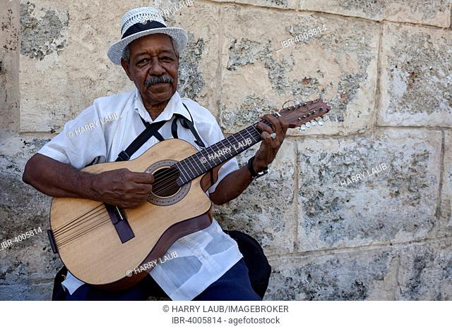 Cuban street musician playing the guitar in Old Havana, Havana, Cuba