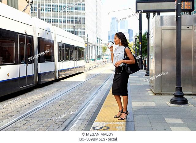 Businesswoman waiting on light rail platform