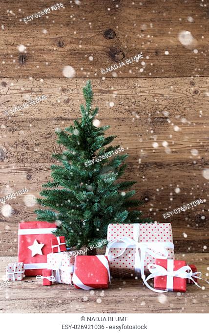 Vertical Christmas Card For Seasons Greetings. Christmas Tree With Gifts Or Presents In The Front Of Wooden Background. With Snowflakes White Ribbon With Bow