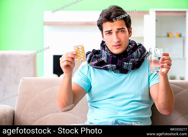 Young handsome man suffering from illness at home