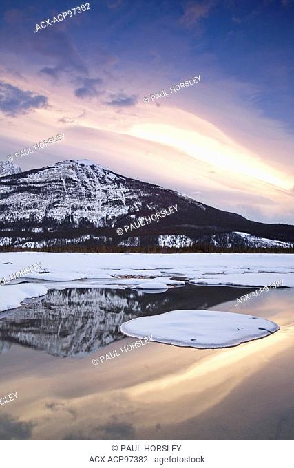 Scenic snow capped mountain reflected in the Athabasca River, Jasper National Park, Canada