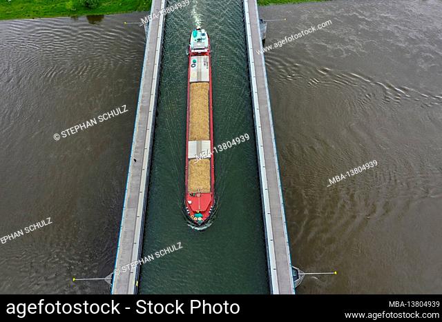 Germany, Saxony-Anhalt, Hohenwarthe, a barge crosses the Magdeburg waterway junction, the Mittelland Canal leads here in a Trpg bridge over the Elbe