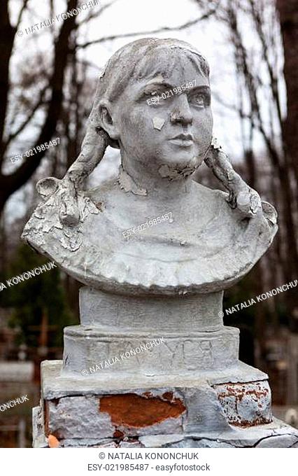 Old cemetery sculpture of the young girl