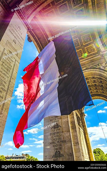 Sunbeam Sun Rays Arc de Triomphe French Flag Paris France. Completed in 1836 monument to the dead in the French Revolution and Napoleonic Wars