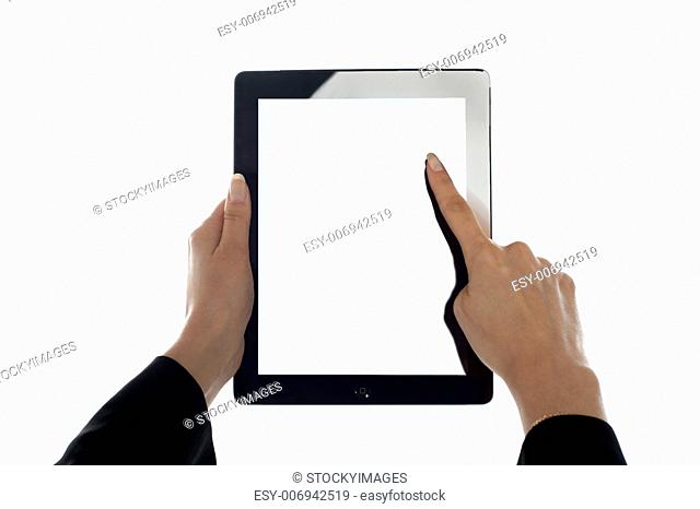 Closeup shot of female finger operating tablet. All on white background