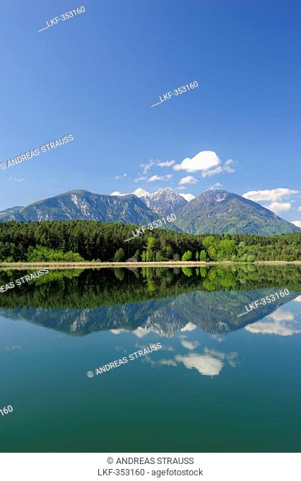 Karawanken range reflecting in lake Turnersee, lake Turnersee, Carinthia, Austria, Europe