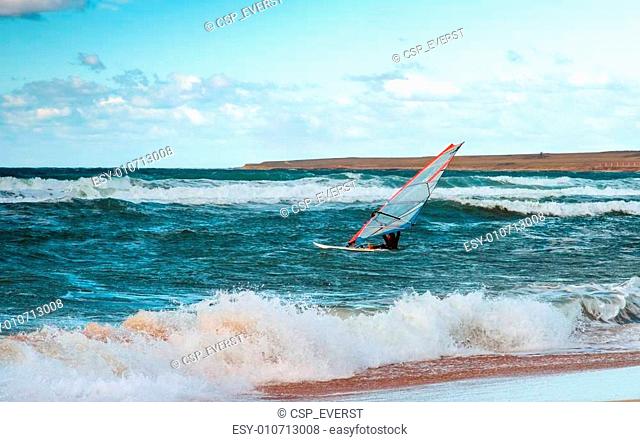 Sea Windsurfing Sport sailing water active leisure Windsurfer training on waves summer day