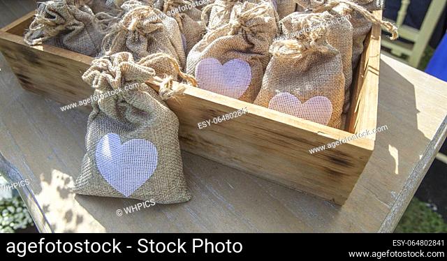 Sachets of rice ready to throw away after a wedding ceremony. Wooden box container