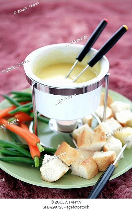 Cheese fondue with vegetables and cubes of bread
