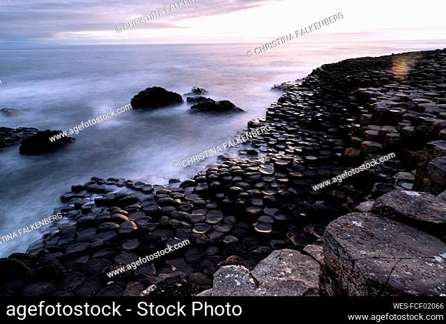 Basalt stones on coastline at sunset, Giant's Causeway, Northern Ireland