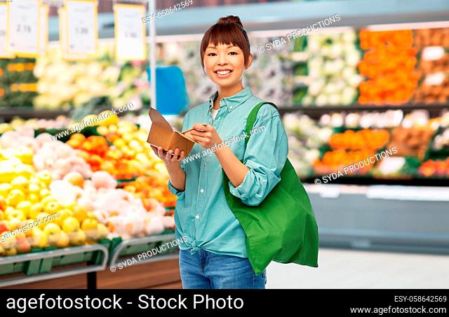 asian woman with reusable bag for food and wok