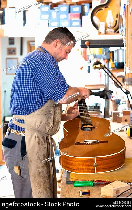 Guitar maker in his workshop