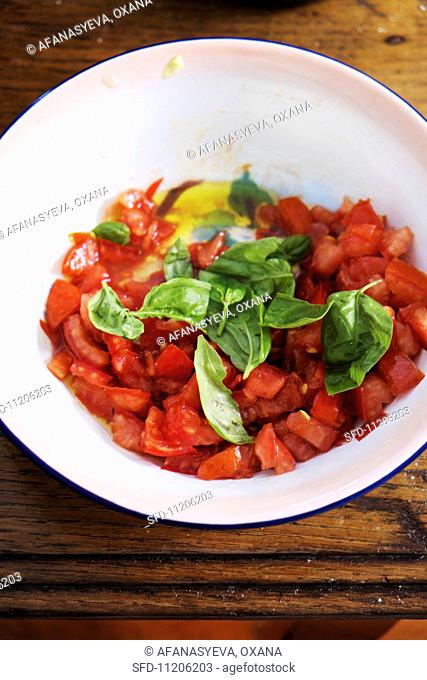 Chopped tomatoes with basil in a bowl