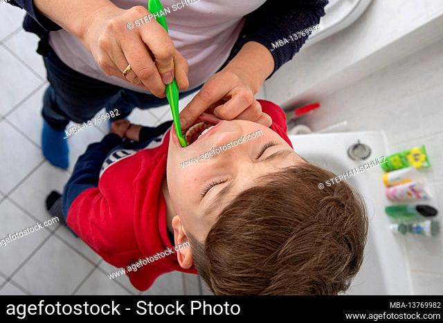 Boys are brushing their teeth
