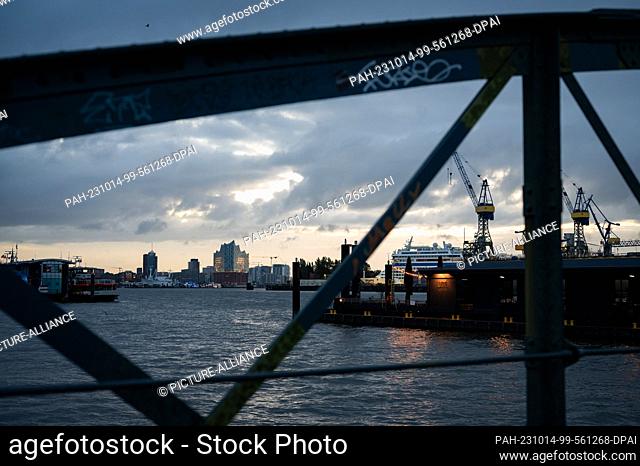 14 October 2023, Hamburg: Gray clouds over the Elbphilharmonie and the harbor in the morning light. Photo: Jonas Walzberg/dpa