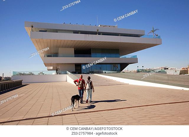 Couple with a dog in front of the Veles e Vents, building by David Chipperfield, Port Americas Cup, Valencia, Spain, Europe