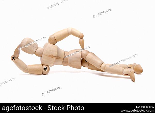 Close up view of a wooden dummy relaxing isolated on a white background