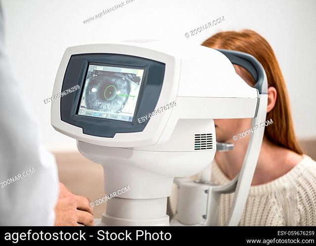 young girl patient on reception at doctor ophthalmologist. diagnostic ophthalmologic equipment. medicine concept