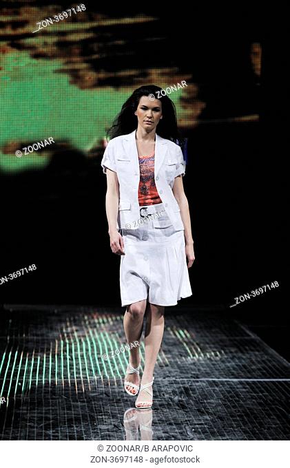 beautiful young fashion model woman walking on fashion show event