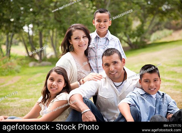 Happy hispanic family portrait in the park