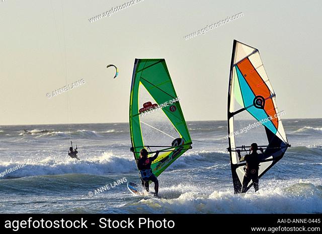 Windsurfers and kitesurfers in action at Bloubergstrand, Cape Town, Western Cape, South Africa