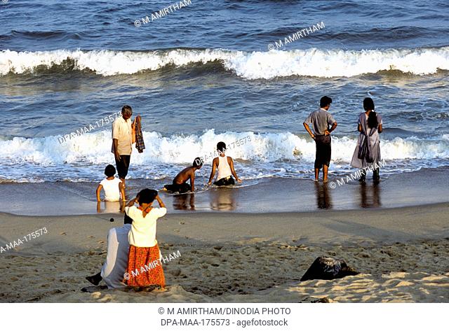 Tourists enjoying on coromandel beach ; Pondicherry ; Tamil Nadu ; India NOMR