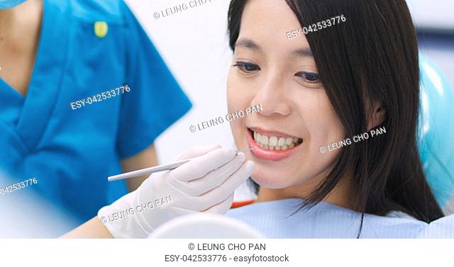 Dentist examining a patient teeth in the dentist