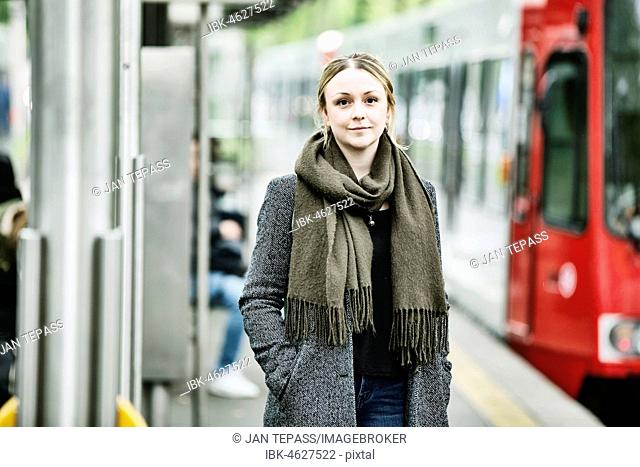 Young woman waiting for the train at a s-Bahn station, Germany