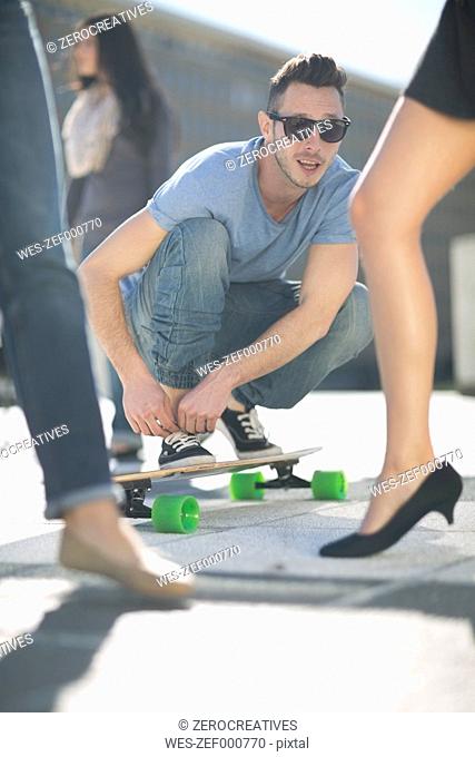 Skate boarder admiring women's legs