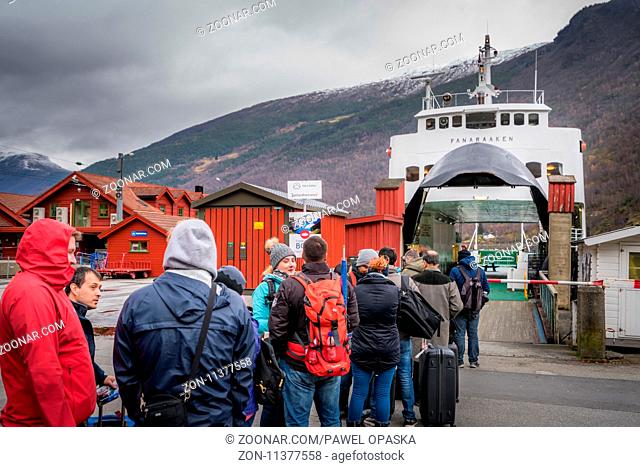 Flam, Norway - October 2017 : Group of tourists waiting for the Norway in a nutshell sightseeing cruise through the magnificent Aurlandsfjord and Naeroyfjord...