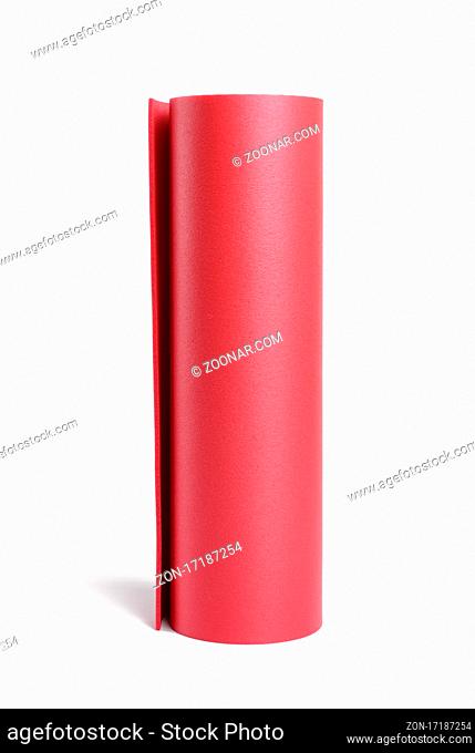 twisted red neoprene sports mat for sports, yoga isolated on white background, close up