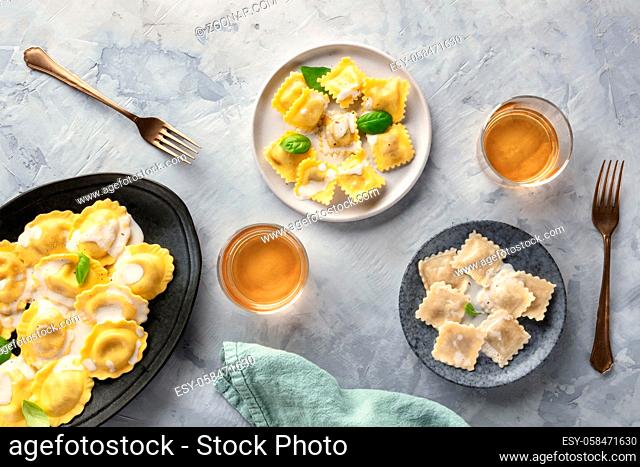 Italian Food. An assortment of various ravioli, shot from above with glasses of white wine