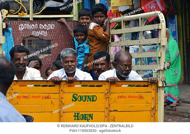 Street scene in Madurai in the south of India - several men and boys sit and stand on a truck, taken on 10.02.2019 | usage worldwide