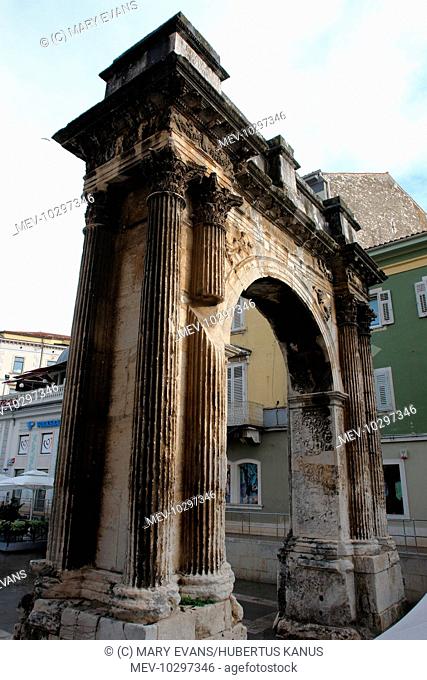 Side view of the triumphal arch of the Sergii at Pula, on the western coast of Istria, Croatia. This ancient Roman arch commemorates three brothers of the...