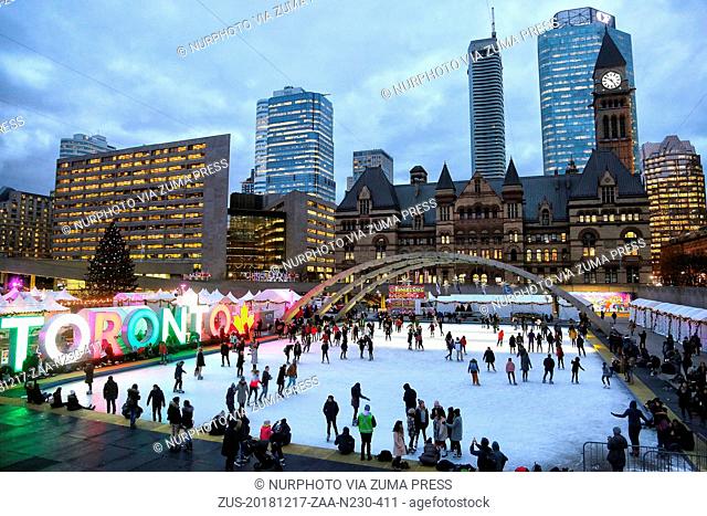 December 17, 2018 - Toronto, Ontario, Canada - People enjoy ice skating at an outdoor ice rink in Nathan Phillips Square in downtown Toronto, Ontario, Canada