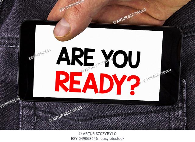 Writing note showing Are You Ready Question. Business photo showcasing asking about availability Lets go out Study Work written Mobile Phone Screen holding by...