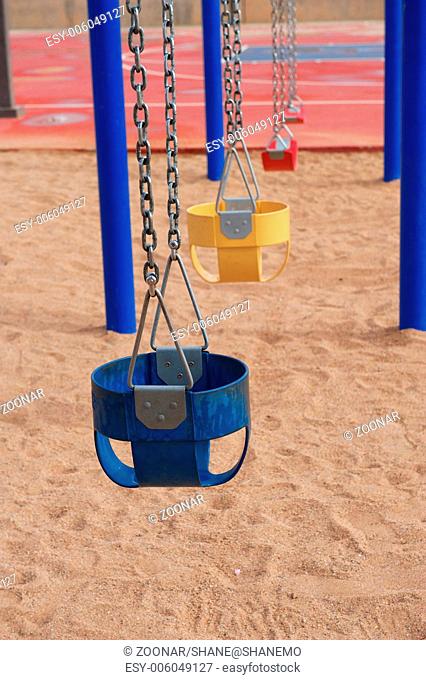 Colorful Empty Swings in Sand