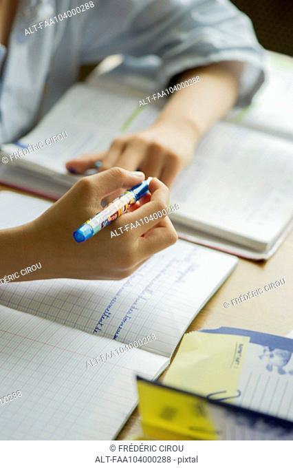 Boy doing homework, cropped