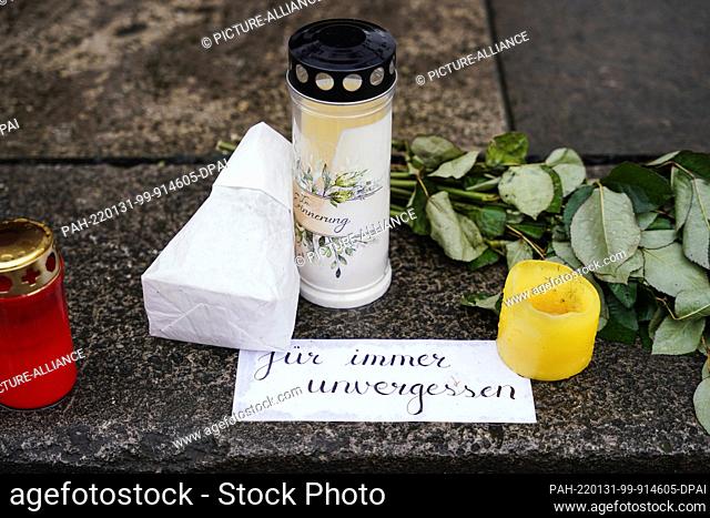 31 January 2022, Baden-Wuerttemberg, Heidelberg: Candles, flowers and a note with the inscription ""forever unforgotten"" have been laid in front of the...