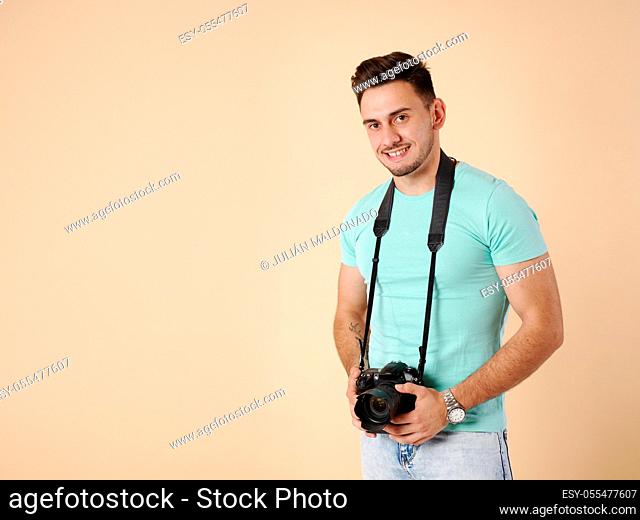 Young professional photographer with his camera and equipment