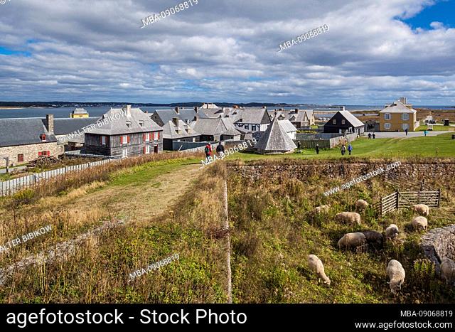 Canada, Nova Scotia, Louisbourg, Fortress of Louisbourg National Historic Park, reconstructed town buildings and sheep pasture