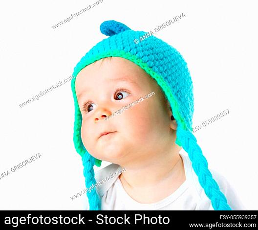 little baby in knitted monkey hat on brown blanket