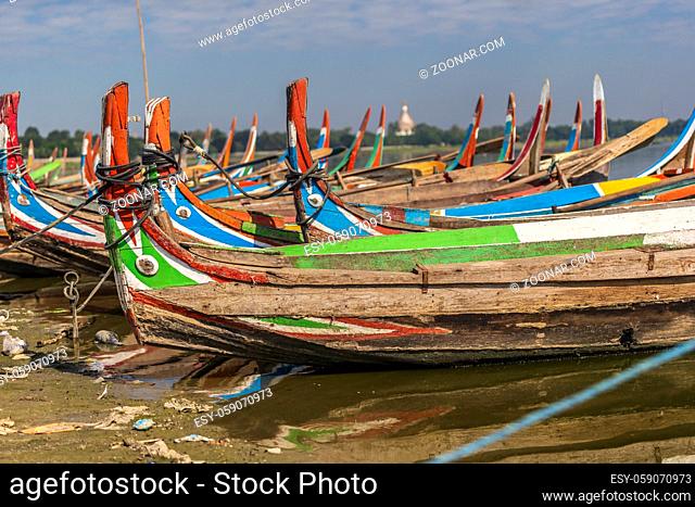 Colourful boats in front of the U Bein bridge
