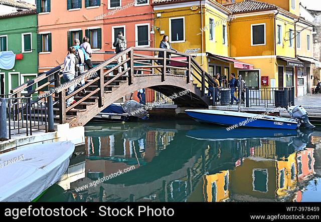 wooden bridge, people, canal, boats, reflections