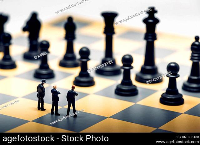Businessmen on a chessboard. Business strategy concept