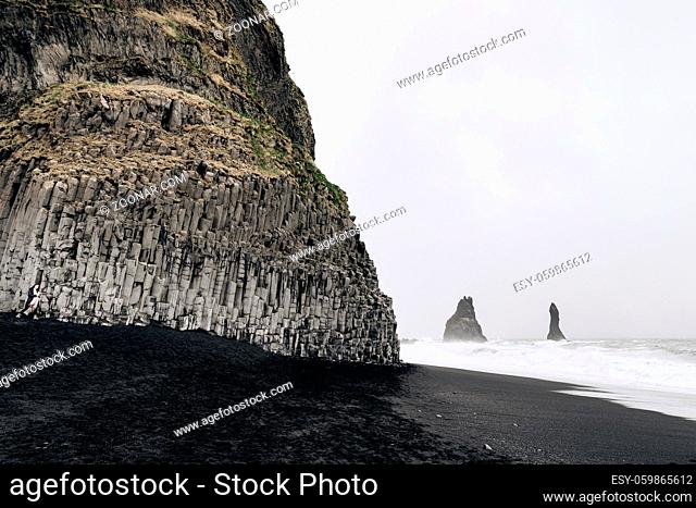Black Beach Vik in Iceland. Waves of the Atlantic Ocean. Basalt pillars on the coast. High quality photo